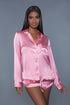 Jenny is a complete vibe. She's Cute, Comfy, & Soft with a hint of Sexy. Jenny is a soft pink two-piece pajama set featuring a long-sleeve button-down revere collar short with white trim, and a cute pocket on the left side. Jenny also features matching drawstring shorts. This set is 100% polyester.